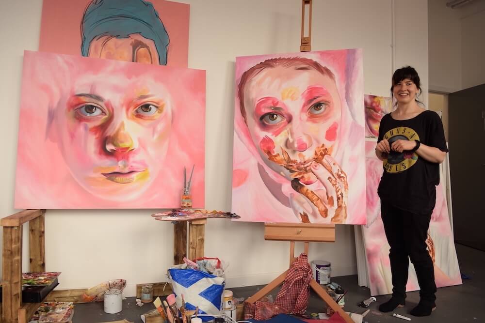 artist studio with large painting of portraits